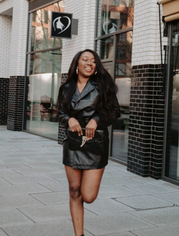 Marcelle Adrianna in a leather set on a city street